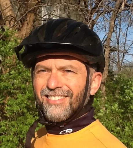 Wayne Logan McDaniel outdoors in a cycling helmet, smiling